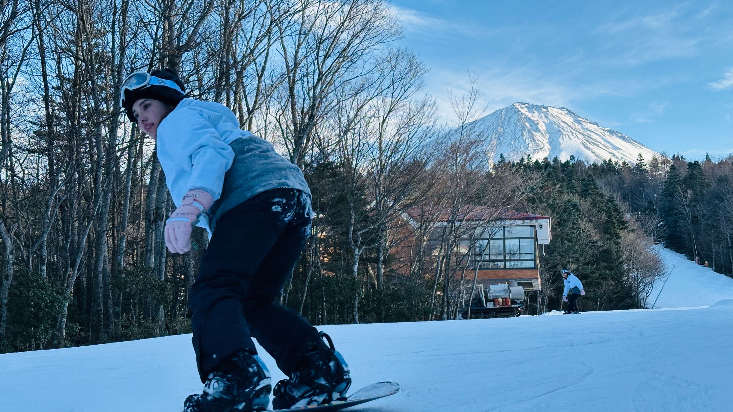 Skiing down a slope facing Mt. Fuji